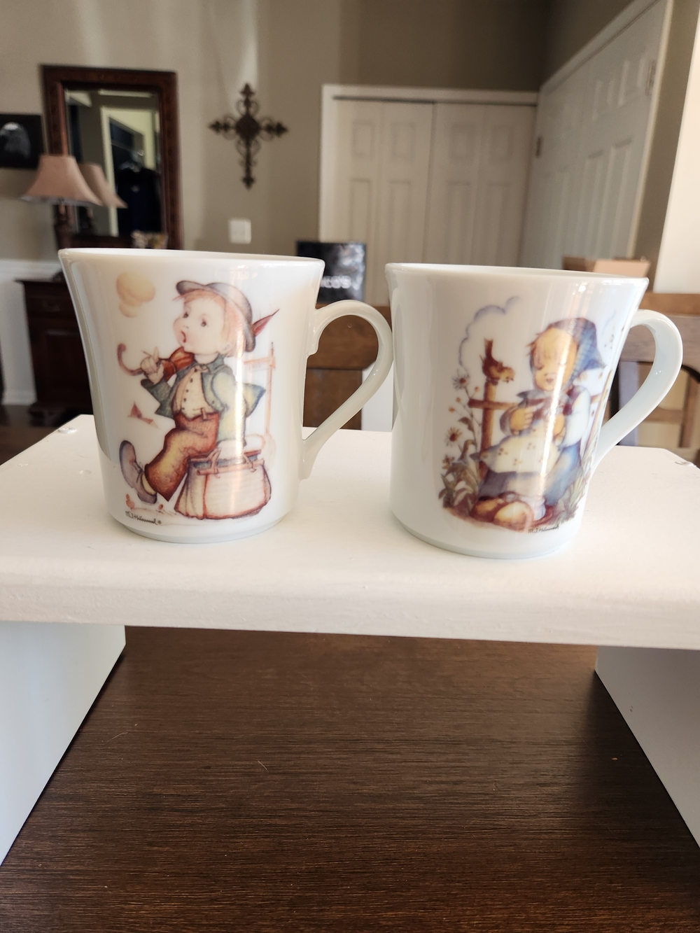 A Pair Of M J Hummel 10oz Mugs, The Merry Wanderer and He Loves Me?